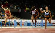 13 August 2014; Tiffany Porter, centre, Great Britain, crosses the finish line to win the women's 100m hurdles final ahead of Cindy Billaud, right, France, who finished second, and Cindy Roleder, Germany, who finished third. European Athletics Championships 2014 - Day 2. Letzigrund Stadium, Zurich, Switzerland. Picture credit: Stephen McCarthy / SPORTSFILE