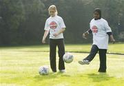 18 October 2006; At a photocall to launch the FAI's Football Against Racism in Europe (FARE) week are Aura Jurciukonyte, left, aged 11, and Huda AbdiHassir Dahir, aged 10, both from St.Gabriels NS, Dublin. The FAI encourages all members of the association to make strong efforts to contribute actively to this anti-racism campaign in football. Merrion Square, Dublin. Picture credit: David Maher / SPORTSFILE