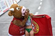 16 August 2014; Jessica Augusto of Portugal celebrates with Cooly the mascot after finishing second in women's marathon. European Athletics Championships 2014 - Day 5. Zurich, Switzerland. Picture credit: Stephen McCarthy / SPORTSFILE