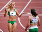 16 August 2014; Ireland's Sarah Lavin, left, with Phil Healy after their 4x100m women's relay team finished 4th and set a new national record time of 43.84 during their round 1 heat. The team consisted of Amy Foster, Kelly Proper, Sarah Lavin and Phil Healy. European Athletics Championships 2014 - Day 5. Letzigrund Stadium, Zurich, Switzerland. Picture credit: Stephen McCarthy / SPORTSFILE