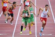 16 August 2014; Thomas Barr running the anchor leg takes over from Richard Morrissey for Ireland during their 4x400m qualifying heat. The team, which finished third and qualified for tomorrow's final, in a new national record time of 3:03.57, also included Brian Gregan and Brian Murphy. European Athletics Championships 2014 - Day 5. Letzigrund Stadium, Zurich, Switzerland. Picture credit: Stephen McCarthy / SPORTSFILE