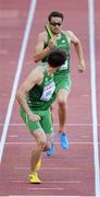 16 August 2014; Brian Gregan running the opening leg looks to change over with Brian Murphy for Ireland during their 4x400m qualifying heat. The team, which finished third and qualified for tomorrow's final, in a new national record time of 3:03.57, also included Richard Morrissey and Thomas Barr. European Athletics Championships 2014 - Day 5. Letzigrund Stadium, Zurich, Switzerland. Picture credit: Stephen McCarthy / SPORTSFILE