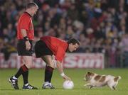 28 October 2006; Referee Shane McInerney tries to catch a dog that strayed onto Pearse Stadium. Coca-Cola International Rules Series 2006, First Test, Ireland v Australia, Pearse Stadium, Galway. Picture credit: Ray Ryan / SPORTSFILE