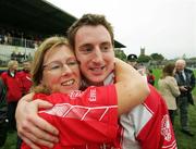 29 October 2006: Irene Malone congratulates her son Alan Malone, Eire Og captain, after victory over Lissycasey. Clare Senior Football Championship Final, Eire Og v Lissycasey, Cusack Park, Ennis, Co. Clare. Picture credit: Kieran Clancy / SPORTSFILE