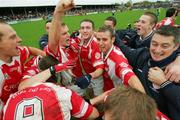 29 October 2006: The Eire Og squad and manager James Hanrahan, right, celebrate victory over Lissycasey. Clare Senior Football Championship Final, Eire Og v Lissycasey, Cusack Park, Ennis, Co. Clare. Picture credit: Kieran Clancy / SPORTSFILE
