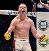 16 August 2014; Joseph Duffy celebrates after submitting Damien Lapilus in Round 3 of their lightweight bout. Cage Warriors 70 Fight Night, The Helix, Dublin. Picture credit: Ramsey Cardy / SPORTSFILE