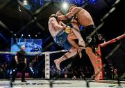 16 August 2014; Paul Redmond, left, in action against Alexis Savvidis during their lightweight bout. Cage Warriors 70 Fight Night, The Helix, Dublin. Picture credit: Ramsey Cardy / SPORTSFILE
