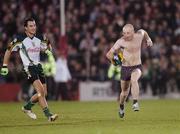 28 October 2006; A Pitch invader runs for it as Irsih player Tadhg Kenneiiy gives cahse at Pearse stadium. Coca-Cola International Rules Series 2006, First Test, Ireland v Australia, Pearse Stadium, Galway. Picture credit: Ray Ryan / SPORTSFILE