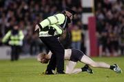 28 October 2006; A Pitch invader stumbles as Gardai close in at Pearse stadium. Coca-Cola International Rules Series 2006, First Test, Ireland v Australia, Pearse Stadium, Galway. Picture credit: Ray Ryan / SPORTSFILE