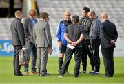 18 August 2014; Referee Tom Connolly, centre, briefs backroom staff and the Bohemians manager Owen Heary and Shamrock Rovers manager Pat Fenlon after the game was deemed unplayable. SSE Airtricity League Premier Division, Bohemians v Shamrock Rovers, Dalymount Park, Dublin. Picture credit: David Maher / SPORTSFILE