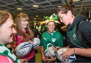 18 August 2014; Ireland's Nora Stapleton signs a ball for supporters in Dublin Airport on her return from the Women's Rugby World Cup in France. Dublin Airport, Dublin. Picture credit: Ramsey Cardy / SPORTSFILE