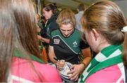 18 August 2014; Ireland's Grace Davitt signs a ball for supporters in Dublin Airport on her return from the Women's Rugby World Cup in France. Dublin Airport, Dublin. Picture credit: Ramsey Cardy / SPORTSFILE