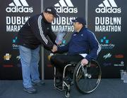 30 October 2006; Richie Powell of Wales is presented with his trophy by Paul Moloney, Sports Marketing Manager, adidas Ireland, after winning the wheelchair race of the 2006 adidas Dublin City Marathon. Merrion Square, Dublin. Picture credit: Brendan Moran / SPORTSFILE