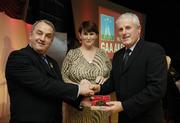 7 November 2006; President of the GAA Nickey Brennan in the company of Carolan Lennon, Director of Marketing, Vodafone, presents Damien Martin, Offaly, a member of the Hurling All Stars of 1971, with a commemorative medal to mark the 35th Anniversary of the Vodafone GAA All-Star Awards scheme at a special celebration in Croke Park, Dublin. Picture credit: Ray McManus / SPORTSFILE
