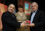 7 November 2006; President of the GAA Nickey Brennan in the company of Carolan Lennon, Director of Marketing, Vodafone, presents Mick Roche, Tipperary, a member of the Hurling All Stars of 1971, with a commemorative medal to mark the 35th Anniversary of the Vodafone GAA All-Star Awards scheme at a special celebration in Croke Park, Dublin. Picture credit: Ray McManus / SPORTSFILE
