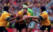 10 October 1999; David Griffin of Australia, centre, supported by team-mates Toutai Kefu, left, and Mark Connors is tackled by Malcolm O'Kelly of Ireland during the Rugby World Cup Pool E match between Ireland and Australia at Lansdowne Road in Dublin. Photo by Brendan Moran/Sportsfile