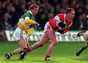 31 October 1999; Jim Holland of Louth in action against David Connolly of Offaly during the National Football League match between Offaly and Louth at O'Connor Park in Tullamore, Offaly. Photo by Damien Eagers/Sportsfile
