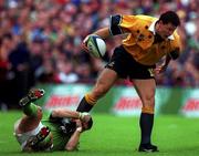 10 October 1999; Matt Burke of Australia is tackled by Tom Tierney of Ireland during the Rugby World Cup Pool E match between Ireland and Australia at Lansdowne Road in Dublin. Photo by Brendan Moran/Sportsfile