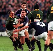 3 October 1999; Robbie Fleck of South Africa is tackled by Stuart Grimes, right, and Scott Murray of Scotland during the Rugby World Cup Pool A match between Scotland and South Africa at Murrayfield Stadium in Edinburgh, Scotland. Photo by Matt Browne/Sportsfile