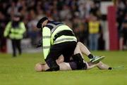 28 October 2006; A Pitch invader caught by a GArda at Pearse stadium. Coca-Cola International Rules Series 2006, First Test, Ireland v Australia, Pearse Stadium, Galway. Picture credit: Ray Ryan / SPORTSFILE