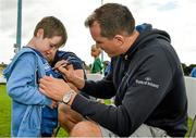 20 August 2014; Adam Lynch, aged 8, from Ballybough, gets an autograph from Leinster and Ireland rugby player Devin Toner during The Herald Leinster Rugby Summer Camps in Clontarf RFC, Dublin. Picture credit: Piaras O Midheach / SPORTSFILE