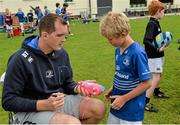 20 August 2014; John McNally, aged 9, from Raheny, gets an autograph from Leinster and Ireland rugby player Devin Toner during The Herald Leinster Rugby Summer Camps in Clontarf RFC, Dublin. Picture credit: Piaras O Midheach / SPORTSFILE