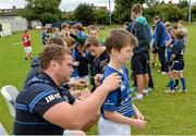 20 August 2014; Oran Redmond, aged 9, from Clontarf, gets an autograph from Leinster and Ireland rugby player Jack McGrath during The Herald Leinster Rugby Summer Camps in Clontarf RFC, Dublin. Picture credit: Piaras O Midheach / SPORTSFILE