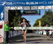 23 August 2014; Maria McCambridge, Dundrum South Dublin A.C, crosses the finish line to win the Frank Duffy 10 Mile SSE Airtricity Dublin Race Series 2014. Phoenix Park, Dublin. Picture credit: Pat Murphy / SPORTSFILE