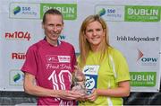 23 August 2014; Maria McCambridge, Dundrum South Dublin A.C, is presented with her trophy by Leanne Sheil, Marketing Executive, SSE Airtricity, right, after winning the Frank Duffy 10 Mile SSE Airtricity Dublin Race Series 2014. Phoenix Park, Dublin. Picture credit: Pat Murphy / SPORTSFILE