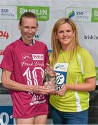 23 August 2014; Maria McCambridge, Dundrum South Dublin A.C, is presented with her trophy by Leanne Sheil, Marketing Executive, SSE Airtricity, right, after winning the Frank Duffy 10 Mile SSE Airtricity Dublin Race Series 2014. Phoenix Park, Dublin. Picture credit: Pat Murphy / SPORTSFILE