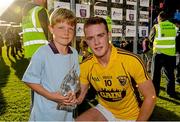 23 August 2014; Jack Guiney, Wexford, is presented with the Bord Gáis Energy Man of the Match award by Max Buggy, aged 7, from Kilanerin, Co. Wexford. Bord Gáis Energy GAA Hurling Under 21 All-Ireland Championship, Semi-Final, Galway v Wexford, Semple Stadium, Thurles, Co. Tipperary. Picture credit: Diarmuid Greene / SPORTSFILE