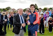 23 August 2014; Cormac McLoughlin, The Hills, is given a presentation after being named man of the match by President of Cricket Ireland Joe Doherty. RSA Irish Senior Cup Final, The Hills v Clontarf, Castle Avenue, Clontarf, Dublin. Picture credit: Piaras Ó Mídheach / SPORTSFILE