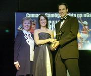 11 November 2006; Galway's Regina Glynn receives her All-Star award from Tadhg Kennelly, footballer with the Sydney Swans, in the company of Liz Howard, President, Cumann Camogaiochta na nGael, speaking at the 2006 Camogie All-Star Awards. Citywest Hotel, Dublin. Picture credit: Brendan Moran / SPORTSFILE