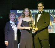 11 November 2006; Cork's Rena Buckley receives her All-Star award from Tadhg Kennelly, footballer with the Sydney Swans, in the company of Liz Howard, President, Cumann Camogaiochta na nGael, speaking at the 2006 Camogie All-Star Awards. Citywest Hotel, Dublin. Picture credit: Brendan Moran / SPORTSFILE