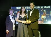11 November 2006; Tipperary's Philly Fogarty receives her All-Star award from Tadhg Kennelly, footballer with the Sydney Swans, in the company of Liz Howard, President, Cumann Camogaiochta na nGael, speaking at the 2006 Camogie All-Star Awards. Citywest Hotel, Dublin. Picture credit: Brendan Moran / SPORTSFILE