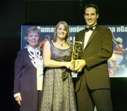 11 November 2006; Cork's Briege Corkery receives her All-Star award from Tadhg Kennelly, footballer with the Sydney Swans, in the company of Liz Howard, President, Cumann Camogaiochta na nGael, speaking at the 2006 Camogie All-Star Awards. Citywest Hotel, Dublin. Picture credit: Brendan Moran / SPORTSFILE