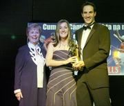 11 November 2006; Cork's Jennifer O'Leary receives her All-Star award from Tadhg Kennelly, footballer with the Sydney Swans, in the company of Liz Howard, President, Cumann Camogaiochta na nGael, speaking at the 2006 Camogie All-Star Awards. Citywest Hotel, Dublin. Picture credit: Brendan Moran / SPORTSFILE