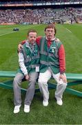 24 August 2014; Representatives from Down Syndrome Ireland and Irish Autism Action, two of the GAA’s partner charities for 2014, provide a guard of honour as the teams enter the pitch as part of the GAA ‘Inclusion Day’. Shane Byrne and David O'Brien who helped out attending to the pitch take a rest on the team bench. Electric Ireland GAA Football All Ireland Senior Championship Semi-Final, Kerry v Mayo, Croke Park, Dublin. Picture credit: Ray McManus / SPORTSFILE