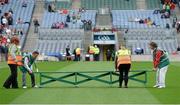 24 August 2014; Representatives from Down Syndrome Ireland and Irish Autism Action, two of the GAA’s partner charities for 2014, help out stadium stewards put the bench out for the team photographs while in their role as temporary members of the Croke Park Stadium ground staff as part of the GAA ‘Inclusion Day’. Electric Ireland GAA Football All Ireland Senior Championship Semi-Final, Kerry v Mayo, Croke Park, Dublin. Picture credit: Brendan Moran / SPORTSFILE