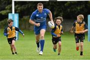 27 August 2014; At the announcement that Bank of Ireland has extended its sponsorship of  Leinster Rugby until end of June 2019 are Leinster's Jamie Heaslip with, from left, Sam Lynam, age 9, his brother Louis Lynam, age 11, and Jack Brennan, age 9, all from Clondalkin RFC. The new five year deal includes exclusive branding of all playing and training kits for the Leinster Rugby professional team and will see Bank of Ireland expand the sponsorship to make a significant additional six figure investment, over five years, to develop the amateur game. The new agreement strengthens Bank of Ireland’s support for Leinster Rugby as it includes support for grass roots level right up to the professional senior team. Clondalkin RFC, Clondalkin, Co. Dublin. Picture credit: David Maher / SPORTSFILE