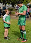 28 August 2014; Pictured in Eyre Square, Galway, is Connacht Rugby player Mils Muliaina signing his autograph for Connacht supporter Caleb Fleetwood, aged 8, from Clarinbridge, Co. Galway. As a 100% Irish owned and operated retailer, LifeStyle Sports today proudly announced its title sponsorship of Connacht Rugby and showcased the new LifeStyle Sports branded Connacht Rugby jersey. Eyre Square, Galway City. Picture credit: Diarmuid Greene / SPORTSFILE