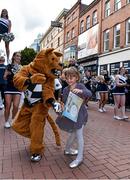 28 August 2014; Ellie Kirkpatrick, age 5, from Dublin, dances with the Nittany Lion, mascot of the Penn State University team, as their marching Band and Cheerleaders performing in Grafton Street, Dublin, ahead of Saturday's Croke Park Classic. The University of Central Florida will face off against Penn State University in the Croke Park Classic on August 30th. The spectacle will include a full days entertainment for all the family featuring an F16 fighter jet flyover, parachute jumps, the Penn State marching band, Extreme Rhythm, The Dublin Gospel Choir, cheerleaders, team mascots and the Super 11’s. Tickets including a special August Family Ticket Offer are still available for the event. Tickets are on sale for the Croke Park Classic through ticketmaster.ie and tickets.ie. For further information visit www.crokeparkclassic.ie. Grafton Street, Dublin. Picture credit: Brendan Moran / SPORTSFILE