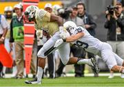 30 August 2014; Jordan Akins, University of Central Florida, is tackled by Jesse Della Valle, Penn State. Croke Park Classic 2014, Penn State v University of Central Florida. Croke Park, Dublin. Picture credit: Pat Murphy / SPORTSFILE