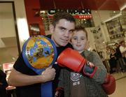 28 November 2006; EBU Super Bantamweight Champion Bernard Dunne with Glenn Ryan, age 9, from Artane, on a visit to Champion Sports to launch it's Christmas range. Champion Sports, Jervis Street Centre, Dublin. Picture credit: Brian Lawless / SPORTSFILE