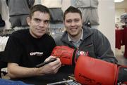 28 November 2006; EBU Super Bantamweight Champion Bernard Dunne signs a glove for Stuart McNeill, from Swords, on a visit to Champion Sports to launch it's Christmas range. Champion Sports, Jervis Street Centre, Dublin. Picture credit: Brian Lawless / SPORTSFILE