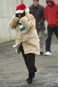3 December 2006; A supporter trys to keep warm as she enters the ground. AIB Leinster Senior Club Football Championship Final, Moorefield v Rhode, O'Moore Park, Portlaoise, Co. Laois. Picture credit: Damien Eagers / SPORTSFILE