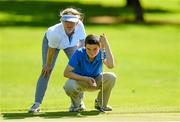 31 August 2013; Bernadett Grogan and Daniel Grogan from Dunmore East Golf Club in County Waterford line up a putt on the 8th green during the All-Ireland Mother and Son medal competition which took place in Malahide Golf Club this weekend. The competition, which is now in its 22nd year is proudly sponsored by Kellogg’s Nutri-Grain. Malahide Golf Club, Malahide, Co. Dublin. Picture credit: Matt Browne / SPORTSFILE