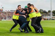 30 August 2014; A Mayo supporter is restrained by security staff after he tries to confront referee Cormac Reilly during the closing stages of the game. GAA Football All Ireland Senior Championship, Semi-Final Replay, Kerry v Mayo. Gaelic Grounds, Limerick. Picture credit: Diarmuid Greene / SPORTSFILE