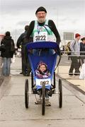 10 December 2006; 82 year old Nick Corish, Raheny Shamrocks, and five month old Aishling Bonner, from Dublin, at the end of the 2006 Dublin Port Tunnel Race. Port Tunnel, Dublin. Picture credit: Tomas Greally / SPORTSFILE