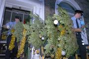 13 December 2006; Two members of the Gardai, remove the christmas tree from the FAI, after a gentleman wearing a Dundalk F.C jersey was taken into Garda custody after an incident at the headquarters of the FAI. The man gave his name to the press as Paul Kavanagh, the Gardai gave his name as Paul McAllister, and he is understood to be a Dundalk steward known as 'Maxie' McAllister. Merrion Square, Dublin. Picture credit: David Maher / SPORTSFILE